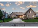 Charming brick home featuring a manicured lawn and a well-maintained landscape with a long driveway at 9626 Oakhaven Ct, Indianapolis, IN 46256