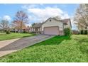 Inviting single-Gathering home with a well-maintained lawn, mature trees, and an attached garage at 990 Bull Run W Dr, Greenwood, IN 46143