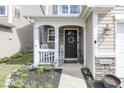 Inviting front porch with stone accents, decorative wreath, and charming decor create a welcoming entrance at 10208 Clear Sky Dr, Avon, IN 46123