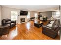Spacious living room with hardwood floors, fireplace, and ample natural light at 10208 Clear Sky Dr, Avon, IN 46123