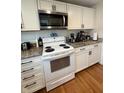 Well-equipped kitchen features granite countertops, white cabinets, and stainless steel appliances at 1041 Hervey St, Indianapolis, IN 46203