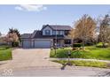 Inviting brick home with mature trees, well-maintained landscaping, and a spacious driveway at 10417 Mayapple Ct, Noblesville, IN 46060