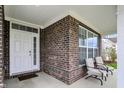Inviting front porch featuring brick accents and comfortable seating for relaxing outdoors at 10811 Wild Orchard Ln, Indianapolis, IN 46239