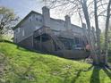 Multi-level wooden decks provide outdoor living space for this hillside home at 11223 Fonthill Dr, Indianapolis, IN 46236