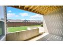 Home features a cozy outdoor space with concrete walls, a lush green lawn and privacy fence at 11436 Mossy Ct # 101, Fishers, IN 46037