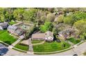 Aerial view showcases the home's prime location in a serene neighborhood with mature trees and well-kept lawns at 11626 Forest Dr, Carmel, IN 46033