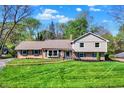 Charming two-story home with landscaped yard, blue shutters, and a well-manicured lawn at 11626 Forest Dr, Carmel, IN 46033