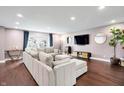 Spacious living room featuring hardwood floors, stylish decor, and a comfortable sectional sofa at 11626 Forest Dr, Carmel, IN 46033