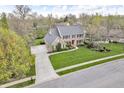 Beautiful aerial view showcasing the home, driveway, and surrounding greenery at 11642 Old Stone Dr, Indianapolis, IN 46236