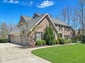 Charming brick home with a three-car garage and lush landscaping at 11642 Old Stone Dr, Indianapolis, IN 46236