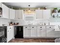 Updated kitchen showcasing white cabinets, countertops, sleek, black appliances, and modern fixtures at 123 Thistlewood Dr, Greenfield, IN 46140