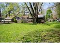 Spacious yard with a fence line, shade trees, and well-maintained lawn at 1410 E 75Th St, Indianapolis, IN 46240