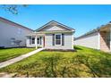 Charming single-story home featuring a red front door, well-kept lawn and complementary landscaping at 14429 Banister Dr, Noblesville, IN 46060