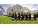 Beautiful home exterior with a well-maintained lawn and a patio area, perfect for outdoor relaxation and entertaining at 15142 Blue Ribbon Blvd, Fishers, IN 46040