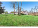 A lush green lawn surrounds a beautiful home, providing a serene outdoor setting at 168 Yorkshire W Blvd, Cumberland, IN 46229