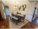 Traditional dining room with wainscoting, stylish lighting, and hardwood floors, perfect for Gathering gatherings at 18756 Brookston Ln, Noblesville, IN 46062