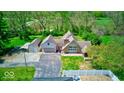 A beautiful aerial view showing the layout of the home, detached garage, and surrounding greenery at 260 17Th St, Columbus, IN 47201