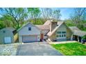 Charming home with stone chimney, two-car garage, and well-manicured lawn, perfect for suburban living at 260 17Th St, Columbus, IN 47201