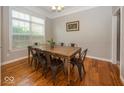 Bright dining room with large windows, wood floors, and modern lighting at 2803 Wild Orchid Way, Columbus, IN 47201