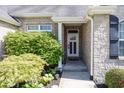 Inviting front entrance with stone accents and manicured landscaping at 2803 Wild Orchid Way, Columbus, IN 47201