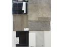 A collection of material samples showing brick, tile, wood, carpet, cabinet and counter selections at 288 Commodore Dr, Pittsboro, IN 46167