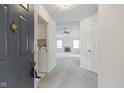 Inviting foyer opens to a bright, carpeted living space with views of a fireplace and abundant natural light at 3114 Village Park N Dr, Carmel, IN 46033
