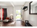 Inviting entryway featuring hardwood floors, coat rack and an open view to the outdoors at 3286 Hemlock St, Whiteland, IN 46184
