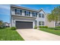 Well-maintained two-story home with a two-car garage, driveway and manicured lawn at 3286 Hemlock St, Whiteland, IN 46184