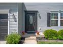 Charming home entrance with a decorative door, outdoor lighting, and well-maintained landscaping at 3286 Hemlock St, Whiteland, IN 46184