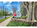 The sign for Tarkington Tower 4000 is surrounded by beautiful green grounds and stonework at 4000 N Meridian St # 9E, Indianapolis, IN 46208