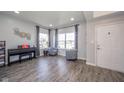 Bright living room with hardwood floors, large windows, and neutral decor provides a warm and inviting ambiance at 403 N Crystal Dr, Fortville, IN 46040
