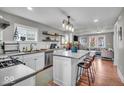 Modern kitchen featuring stainless steel appliances, white cabinets, and an island with seating at 4125 Rookwood Ave, Indianapolis, IN 46208
