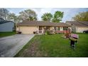 Cozy single-Gathering home with a neat front yard and attached one car garage at 4411 Rotterdam Dr, Indianapolis, IN 46228