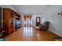 Inviting living room featuring hard wood floors, a large TV, and a comfortable chair at 4411 Rotterdam Dr, Indianapolis, IN 46228
