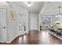 Bright foyer with hardwood floors, white trim, and views to the dining room at 5635 Pennycress Dr, Noblesville, IN 46062