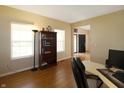 Inviting home office with natural light and hardwood floors; equipped with a bookshelf and a comfortable workspace at 5702 Saratoga Pl, Plainfield, IN 46168