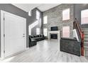 Spacious living room with a brick fireplace, high ceilings, and plenty of natural light at 5954 Crowley Pkwy, Whitestown, IN 46075