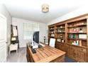 Functional office space features a built-in bookcase and a spacious wood desk, perfect for productivity at 6040 Juniper Ct, Whitestown, IN 46075