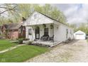 Charming single-story home with front porch, well-maintained lawn, and stone driveway at 6180 Crittenden Ave, Indianapolis, IN 46220