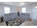 Inviting living room with neutral walls, two gray sofas, and a decorative rug, perfect for entertaining at 6315 Shelbyville Rd, Indianapolis, IN 46237