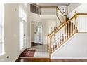 Spacious foyer features tile and wood flooring, staircase, and bright, natural light at 6527 Briarwood Pl, Zionsville, IN 46077