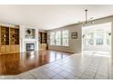 Bright living room with hardwood floors, built-in bookcases, fireplace, and large windows at 6527 Briarwood Pl, Zionsville, IN 46077