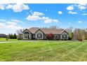 Beautiful single-story home featuring manicured lawn and mature trees at 6829 Whitetail Woods Ct, Bargersville, IN 46106
