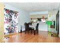 Comfortable dining area with hardwood floors and view to the kitchen, creating a perfect space for meals at 7108 Hearthstone Way, Indianapolis, IN 46227