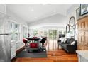 Bright living room with hardwood floors, neutral paint, and dining area at 7456 Heather Ct, Nineveh, IN 46164