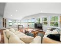 Bright living room features hardwood floors, comfortable couches, natural light, and a table with a board game at 7456 Heather Ct, Nineveh, IN 46164