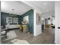 View of the modern living room with hardwood floors, wainscotting, designer lighting, and open concept design at 769 Rose Garden Way, Westfield, IN 46074