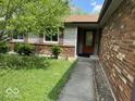 Home exterior with a brick facade, well-kept yard, and a welcoming front entrance at 7833 Broadview Dr, Indianapolis, IN 46227