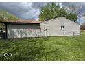 The side exterior of a house with gray siding and a well-maintained lawn at 7833 Broadview Dr, Indianapolis, IN 46227