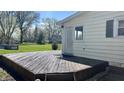 Backyard deck, with a step-down design, offers ample space for outdoor activities and enjoyment at 8200 E Desoto St, Muncie, IN 47303